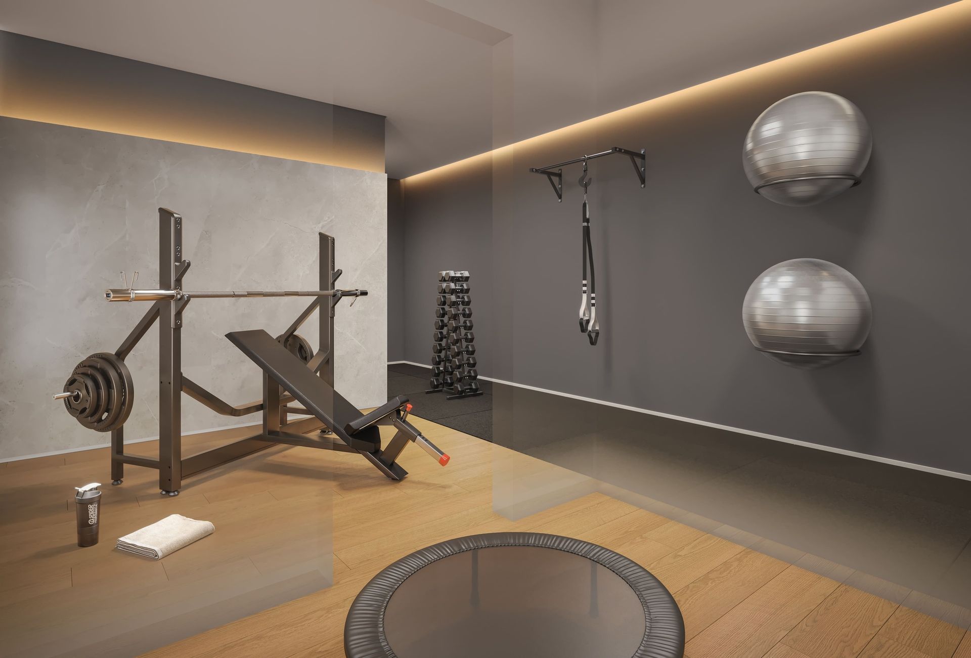 Interior de ginásio com banco de musculação, pesos livres e bolas de ginástica.