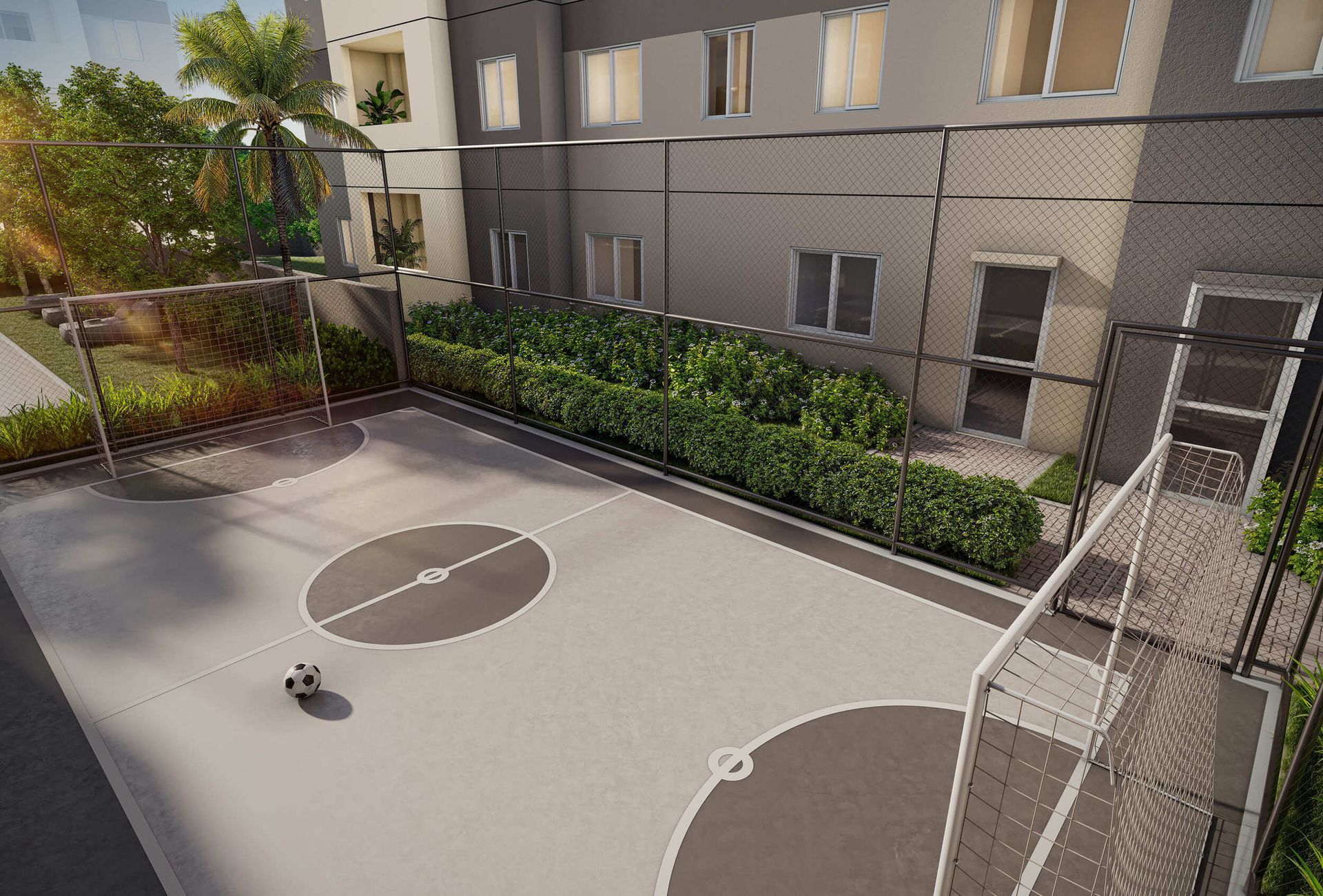 Quadra poliesportiva ao ar livre com cestas de basquete e uma cerca viva em frente a um prédio.