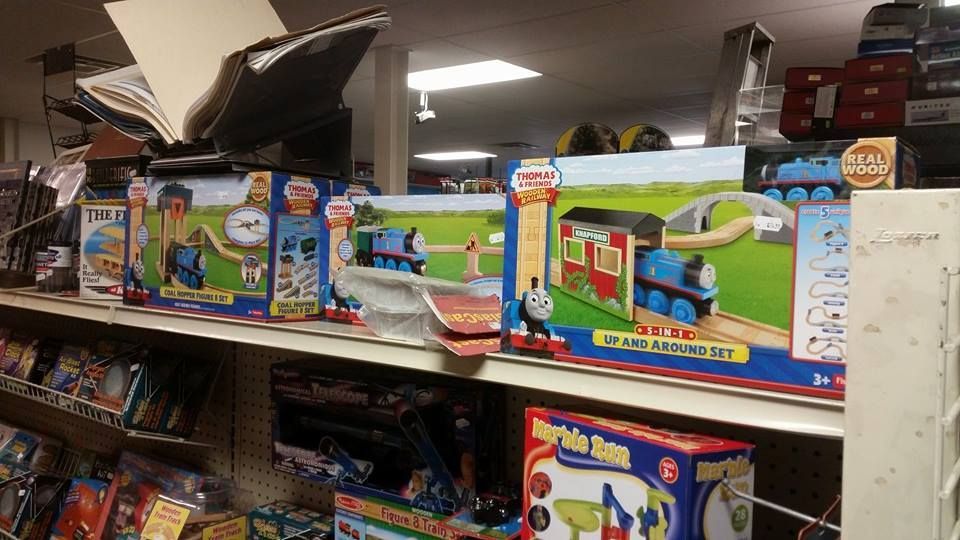 A store shelf filled with lots of toys including thomas the train