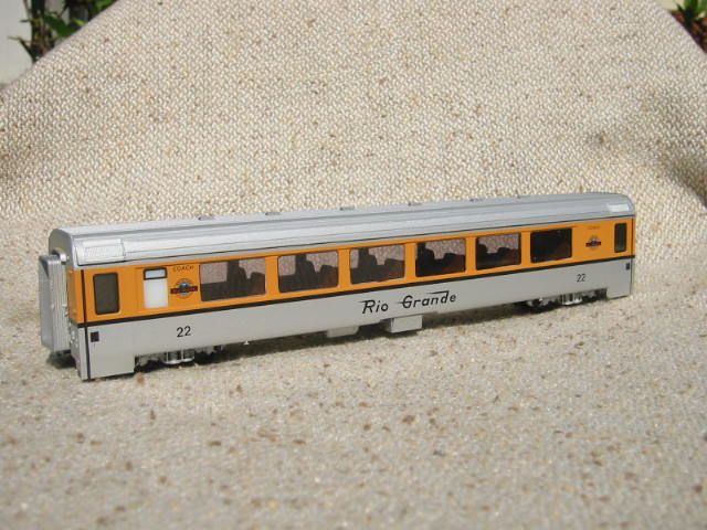 A rio grande train car is sitting on a pile of sand