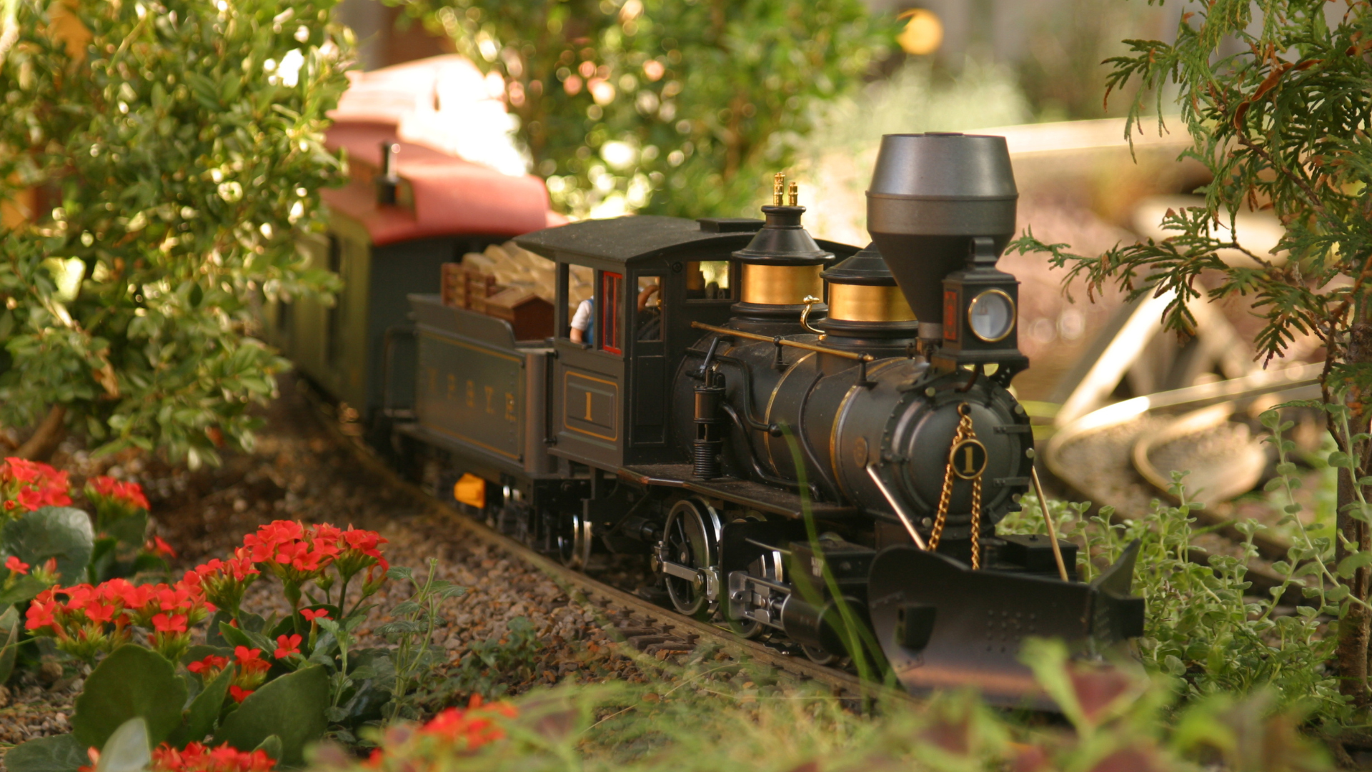 A toy train is sitting on top of a wooden table.