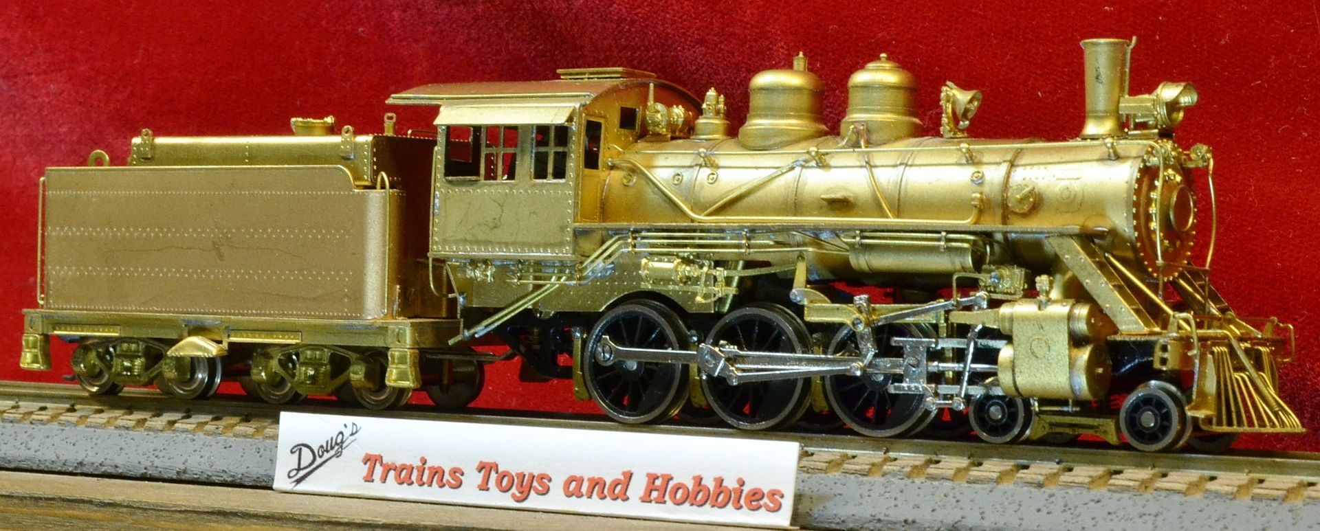 A model train with a sign that says trains toys and hobbies