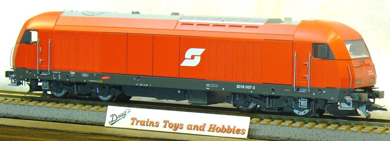 A model train is sitting on the tracks next to a sign that says trains toys and hobbies