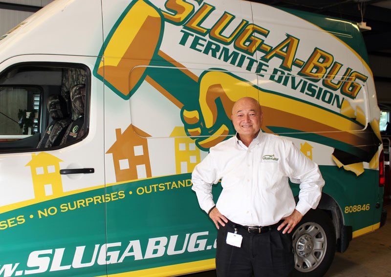 Steve Lum, President of Slug-A-Bug stands in front of a company van