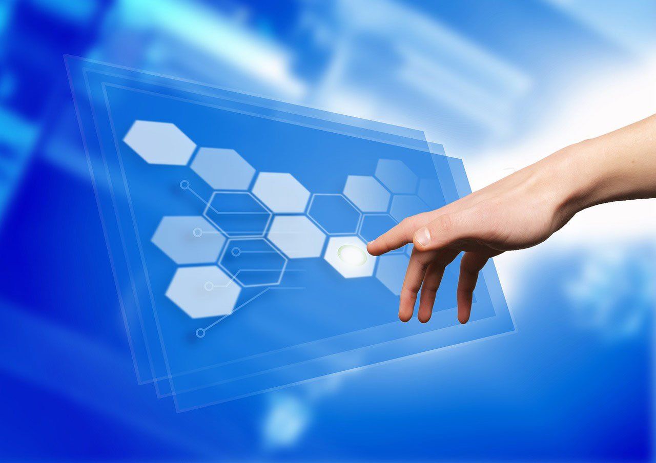 A hand is touching a screen with hexagons on it