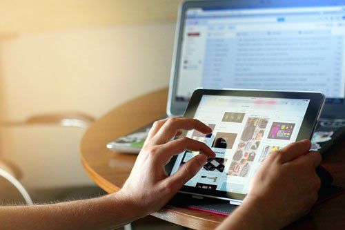 close-up of hand scrolling on a tablet