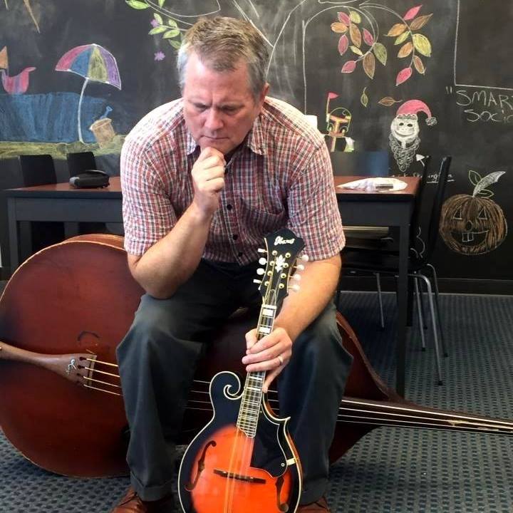 Steve Jones sits on a double bass