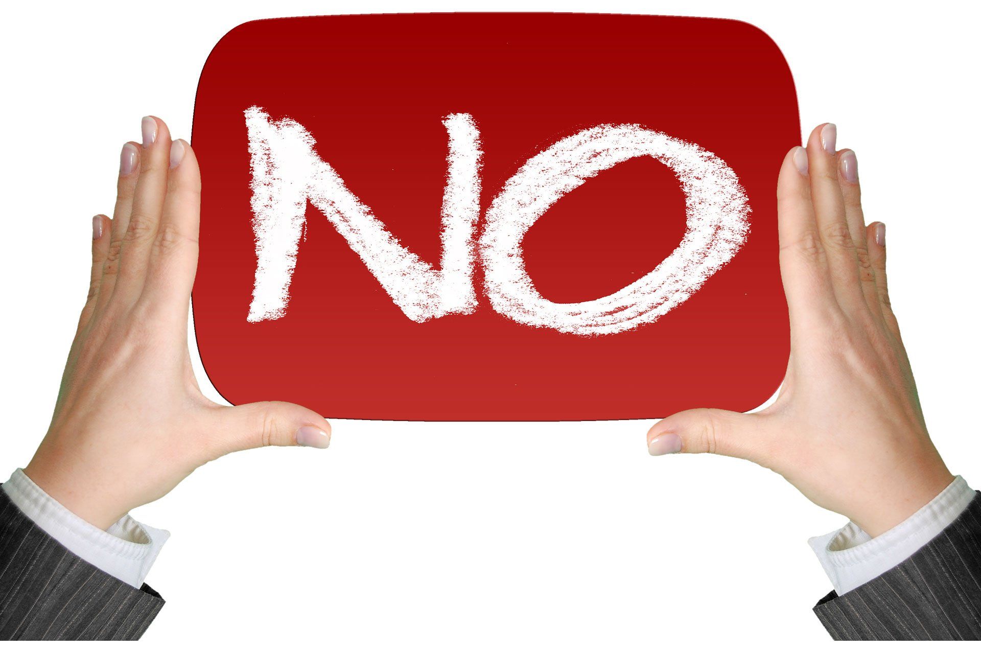 A person is holding a red sign that says no