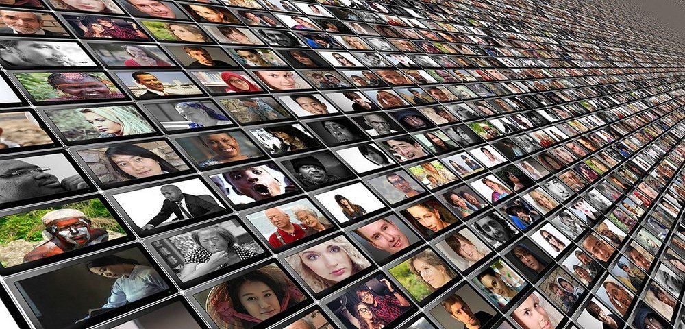 A wall filled with lots of pictures of people 's faces.