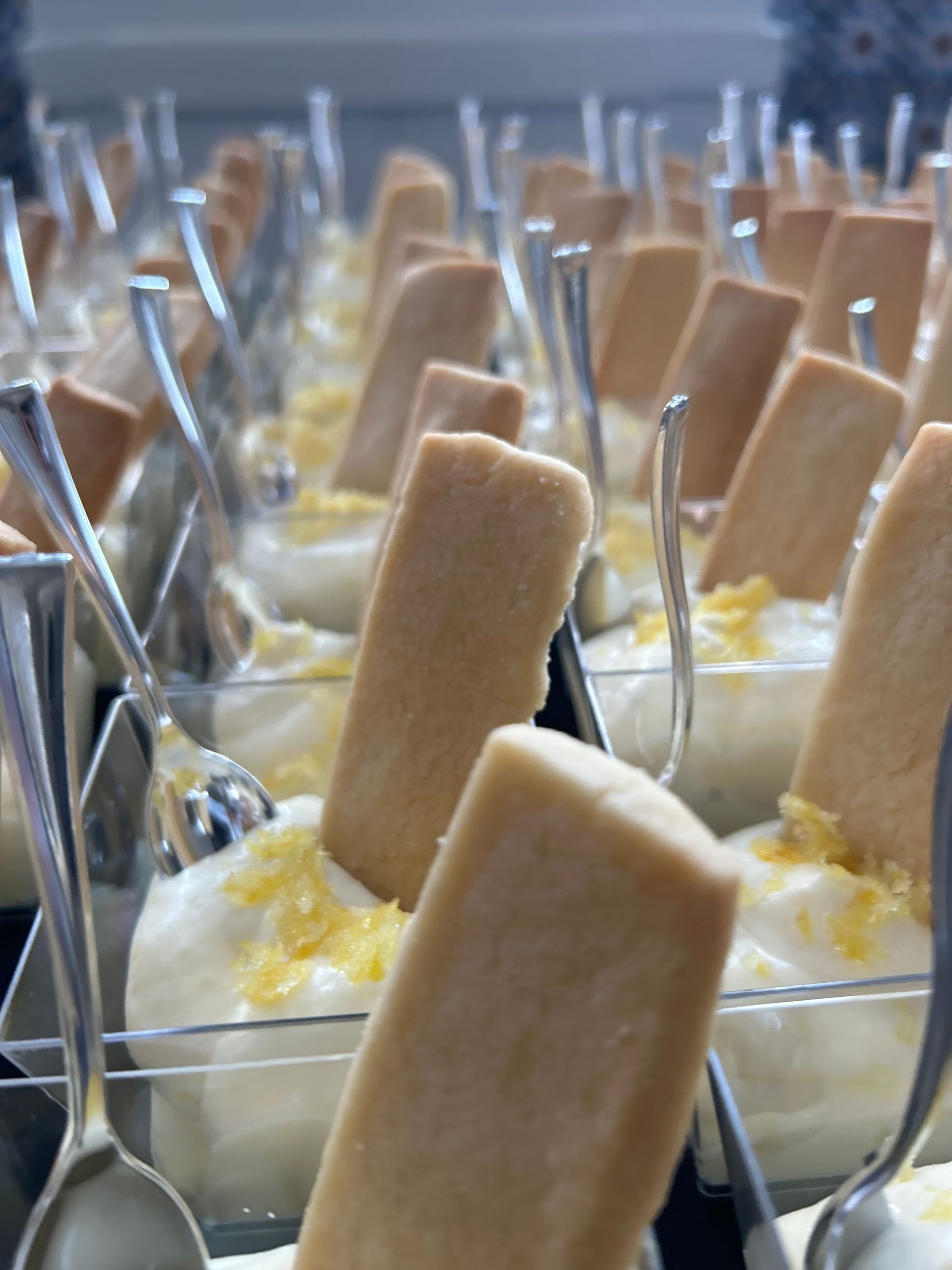 A close up of a tray of desserts with cookies and spoons