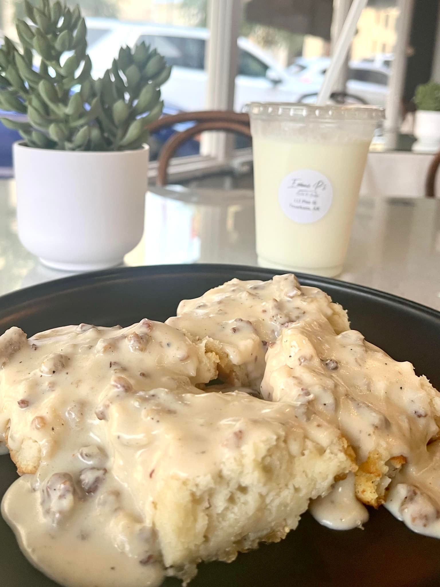 A plate of food and a cup of milk on a table.