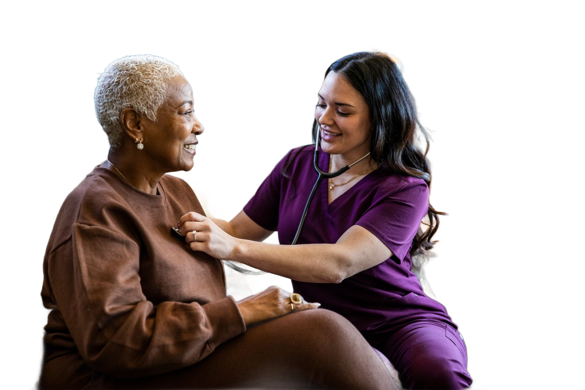 Nurse listening to older woman's heart with a stethoscope. Both are smiling.