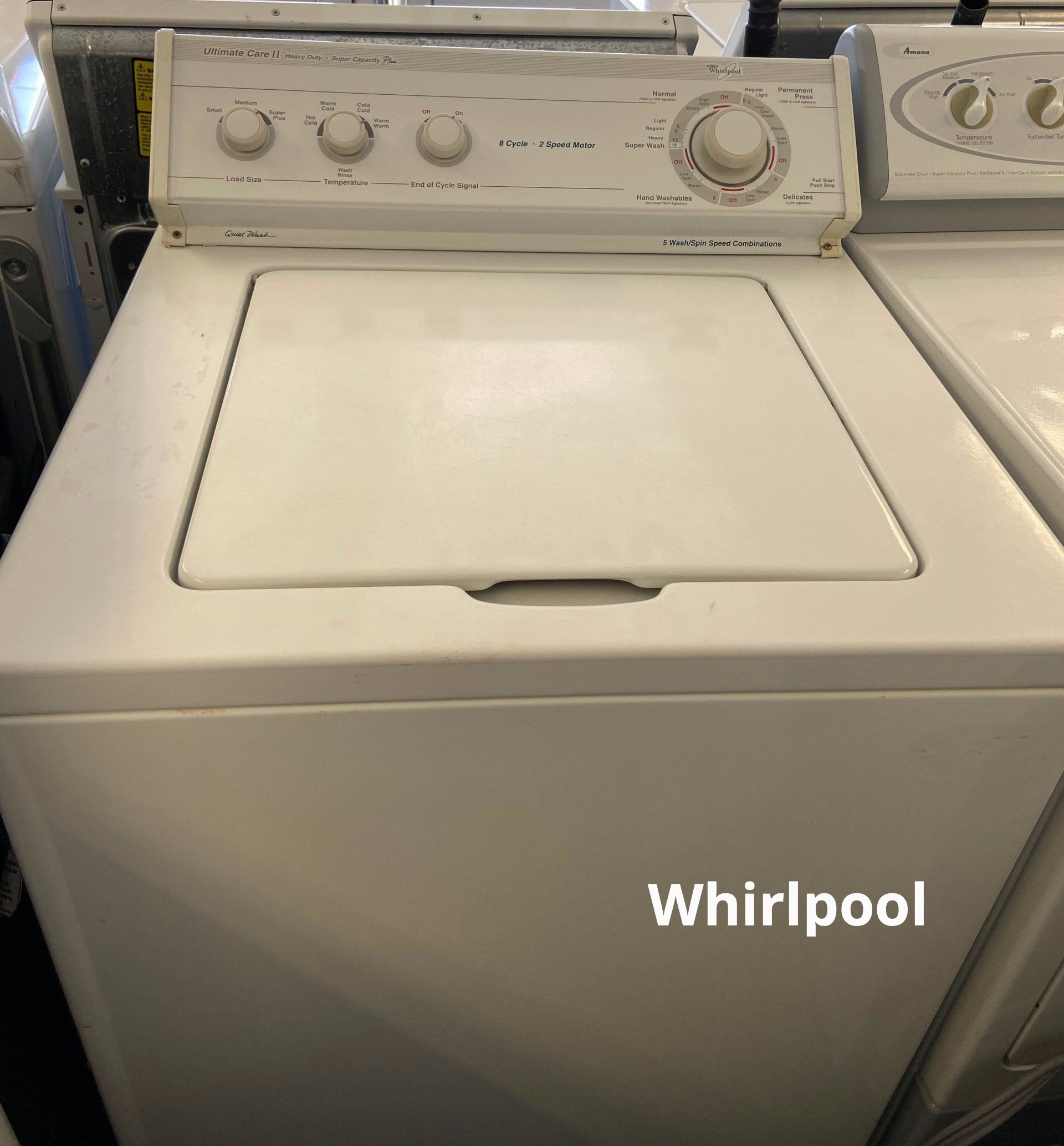 A white whirlpool washer and dryer in a store