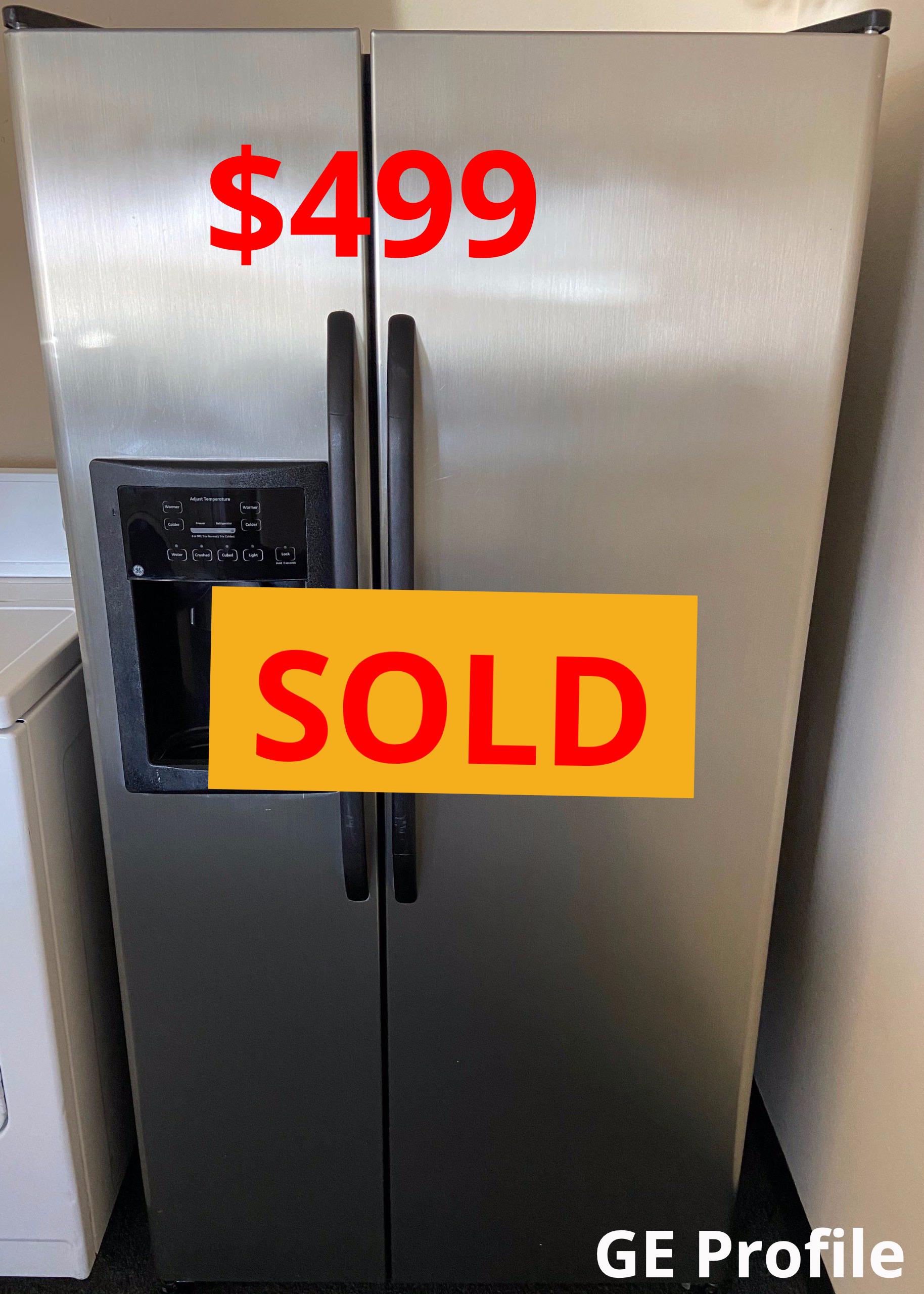 A stainless steel refrigerator with a sold sign on it