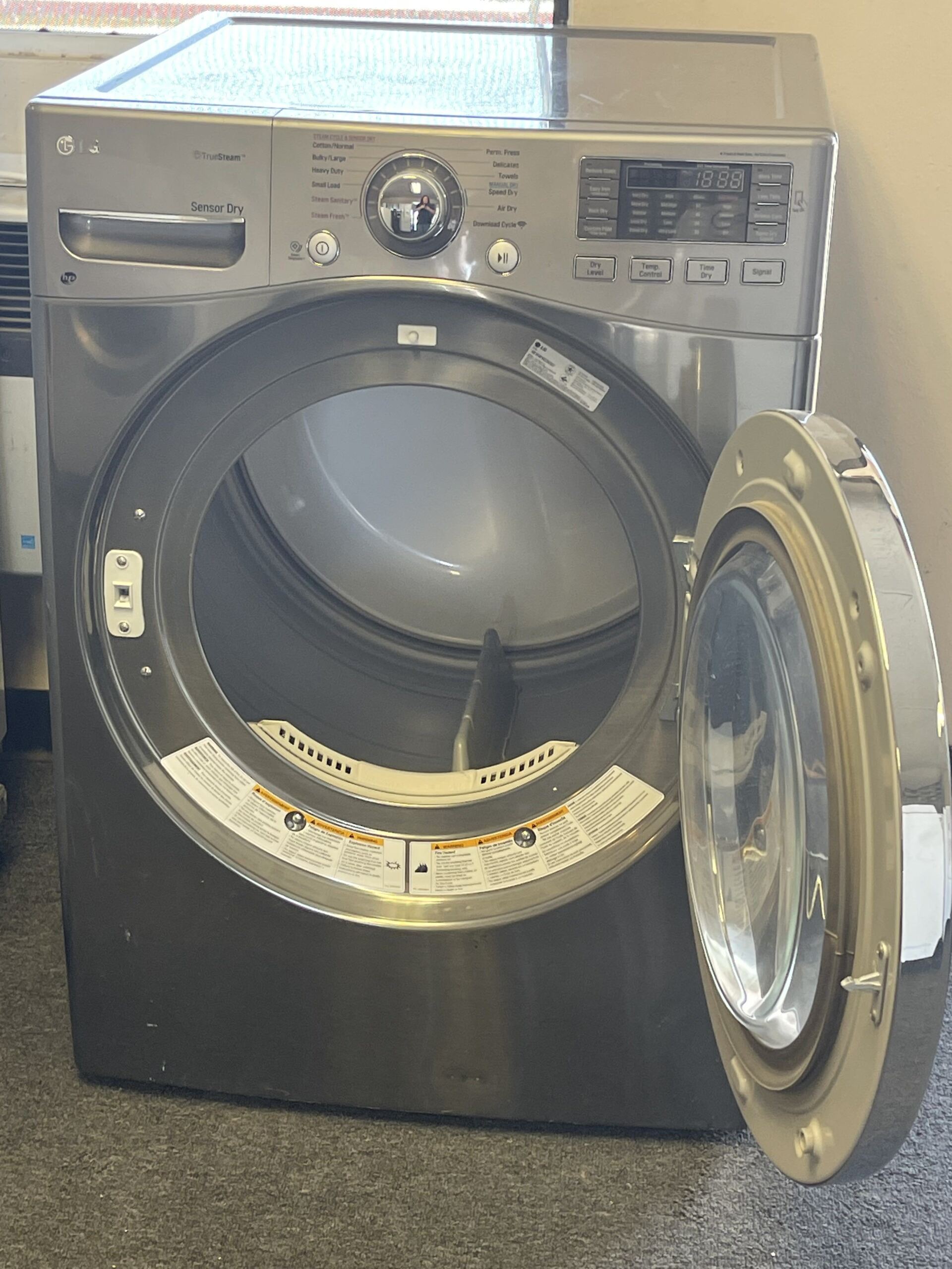 A stainless steel washer and dryer with the door open