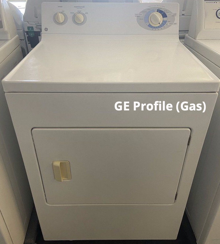 A white ge profile gas dryer is sitting in a laundromat.
