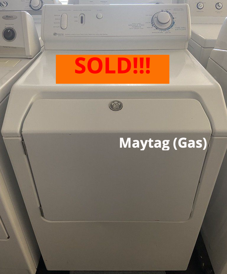 A white dryer with a sold sign on it