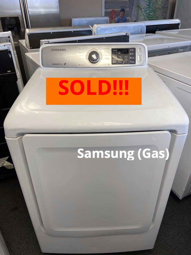 A white samsung gas dryer is sitting on a carpet.