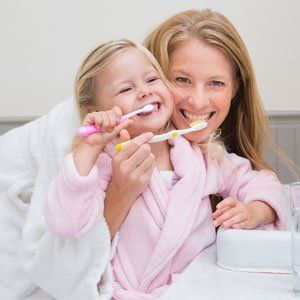 Mother and daughter brushing teeth - Dentist in Grayslake, IL