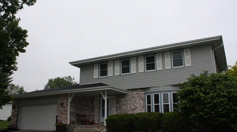 House with Bricks and Siding — Waukee, IA — Allstate Gutter & Siding