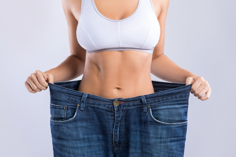 A woman is wearing a pair of very large jeans.