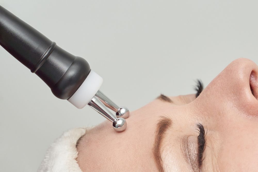 A woman is getting a botox injection in her lips.