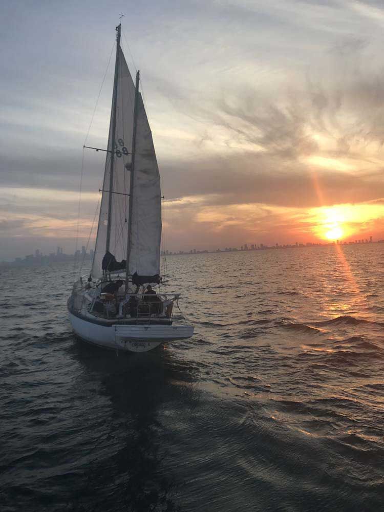 A sailboat is docked at a dock in a harbor.