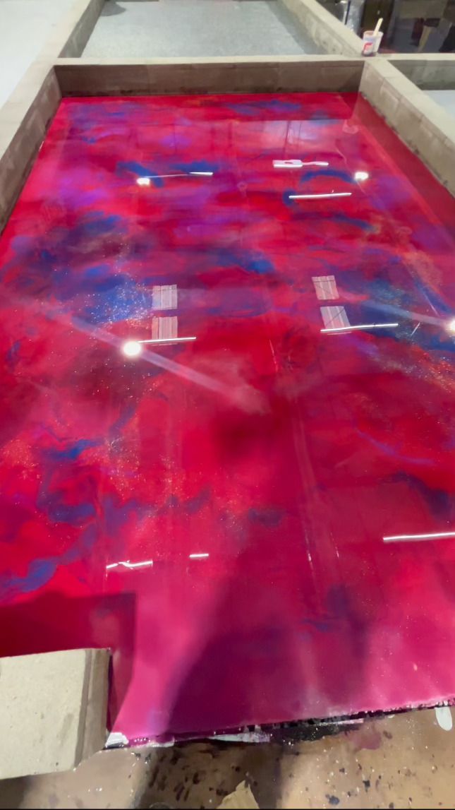 A large empty room with a yellow floor and white walls.