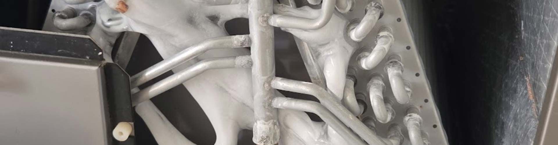 Close-up of white twisted cables beside a gray metal component in a dark industrial setting