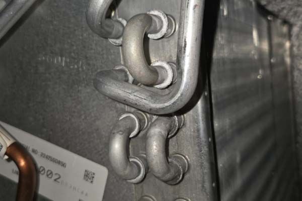 Close-up of metal chain links attached to a gray industrial surface