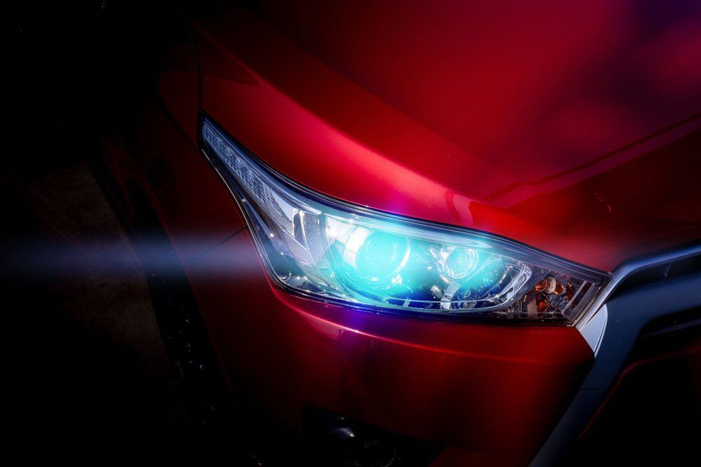 A Close Up of a Red Car 's Headlight With a Blue Light Coming Out of It — K & T Ballina Mechanical In Ballina, NSW