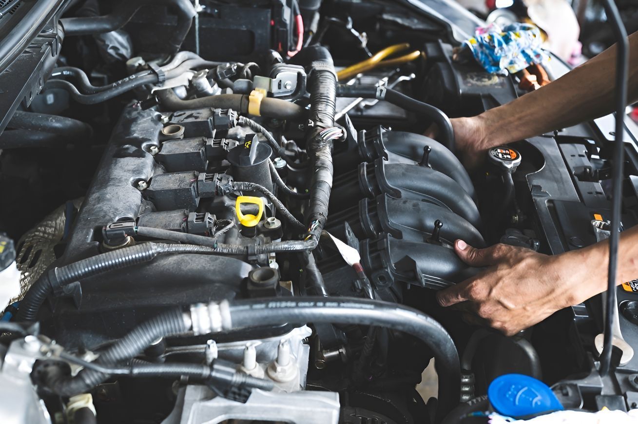 A Person is Working on the Engine of a Car — K & T Ballina Mechanical In Ballina, NSW