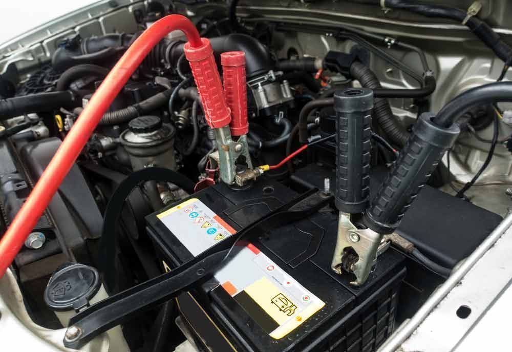 A Car Battery is Being Charged With Jumper Cables — K & T Ballina Mechanical In Ballina, NSW