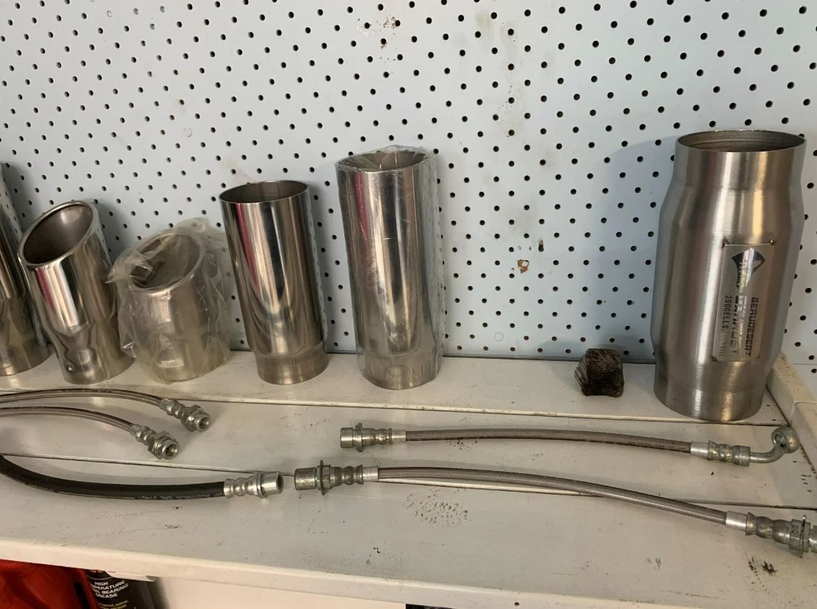 A Shelf Filled With Stainless Steel Exhausts — K & T Ballina Mechanical In Ballina, NSW