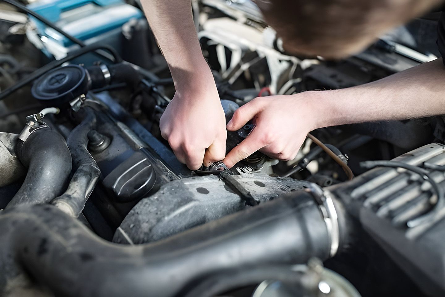 Mechanic Working On A Car Engine Compartment