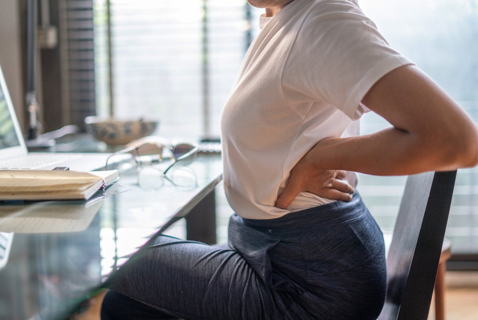 Women Aching Back Pain — Lincoln, NE — Freeman Chiropractic Clinic