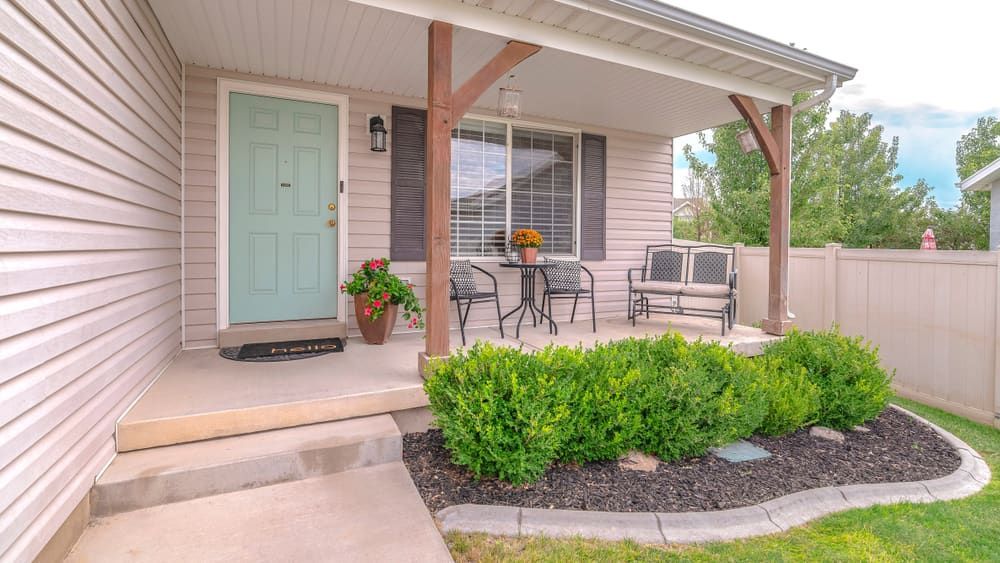 A Cozy Front Porch With a Pastel Green Door — Brett Continuous Concrete Kerbing & Edging In Lakewood, NSW