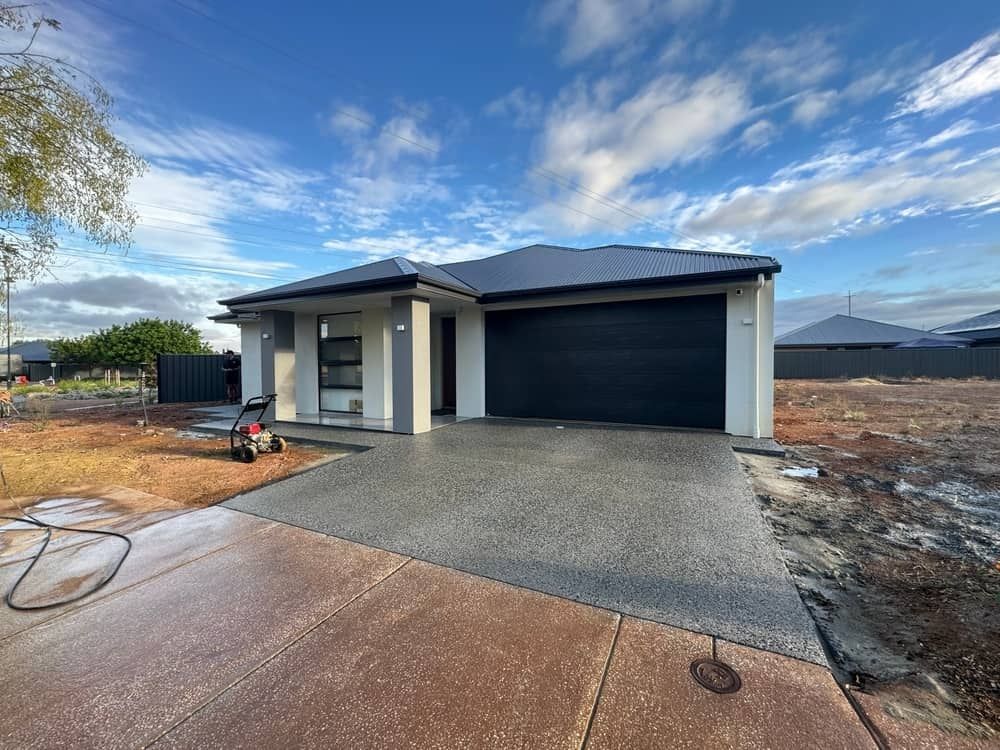  Modern House With Dark Roof and Double Garage — Brett Continuous Concrete Kerbing & Edging In Lakewood, NSW