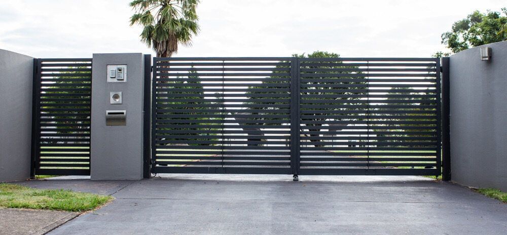 A Black Metal Gate With Horizontal Slats — Brett Continuous Concrete Kerbing & Edging In Lakewood, NSW