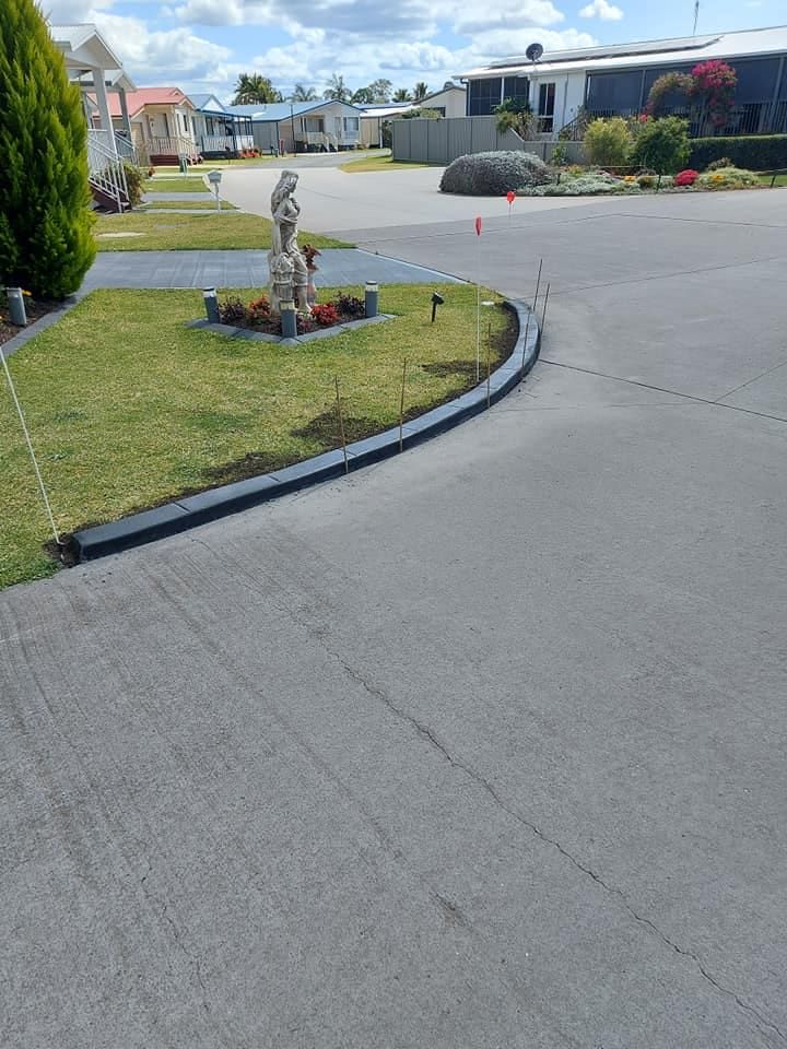 Curved Driveway With Statues — Brett Continuous Concrete Kerbing & Edging In Lakewood, NSW