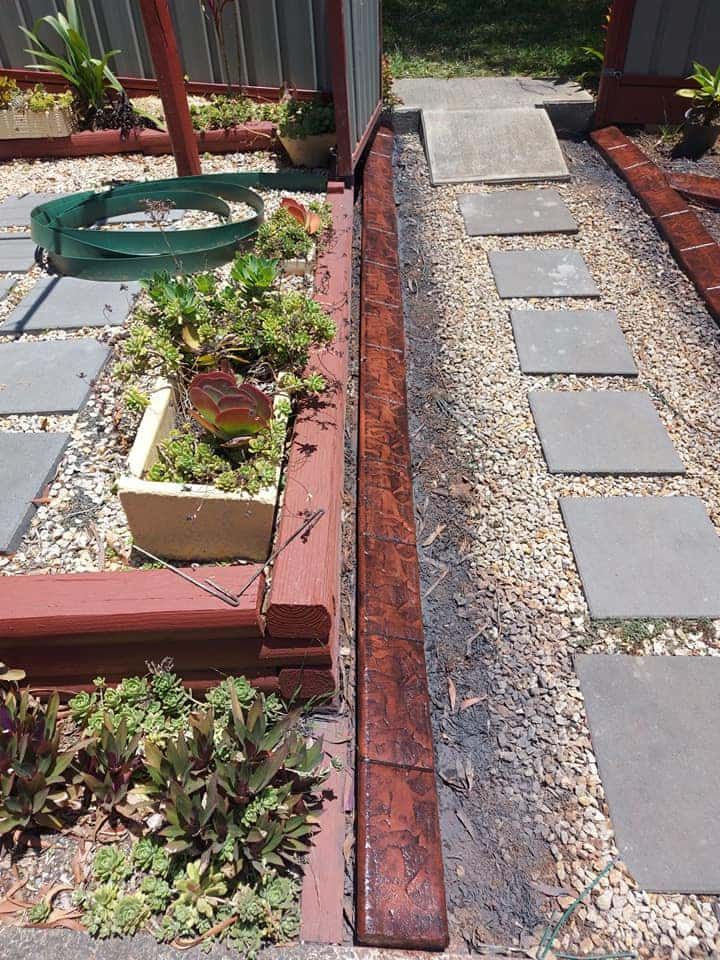 Raised Garden Bed With Succulents and Vibrant Red Edging — Brett Continuous Concrete Kerbing & Edging In North Haven, NSW