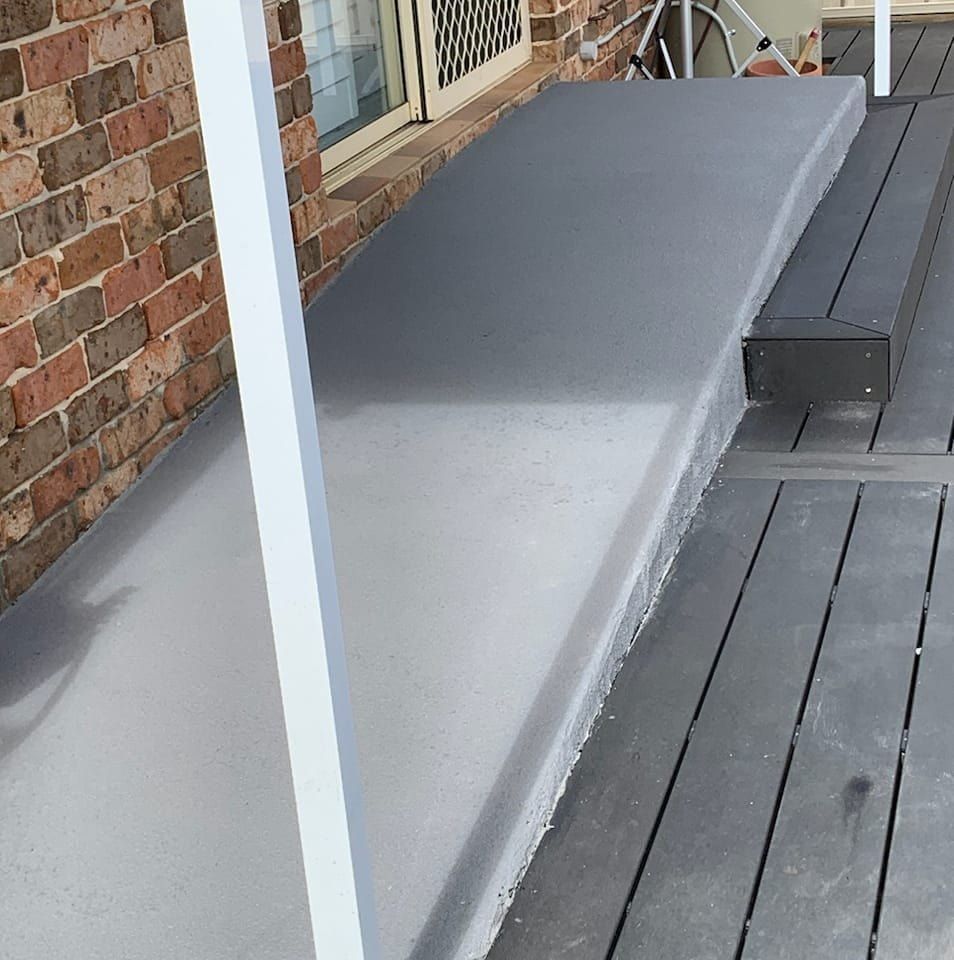 Grey Concrete Step Leading to a Wooden Deck — Brett Continuous Concrete Kerbing & Edging In Lake Cathie, NSW