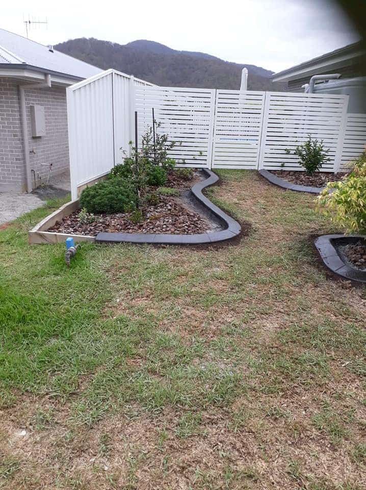 A Backyard Garden Bordered Flower Beds — Brett Continuous Concrete Kerbing & Edging In Lake Cathie, NSW