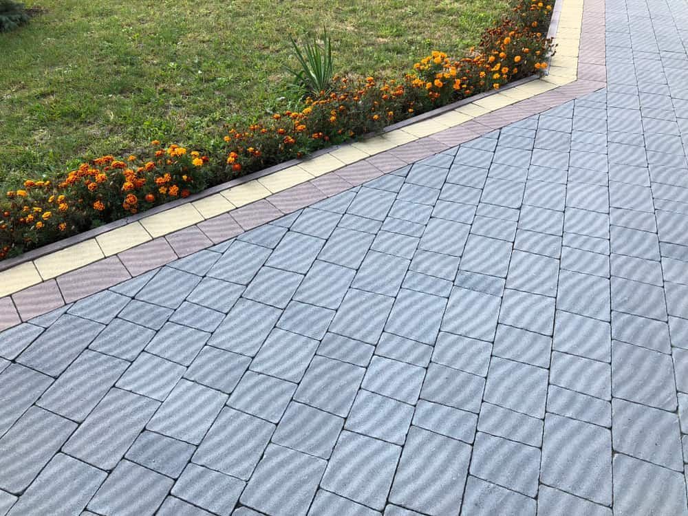 Interlocking Grey Tiles Form a Pathway — Brett Continuous Concrete Kerbing & Edging In North Haven, NSW
