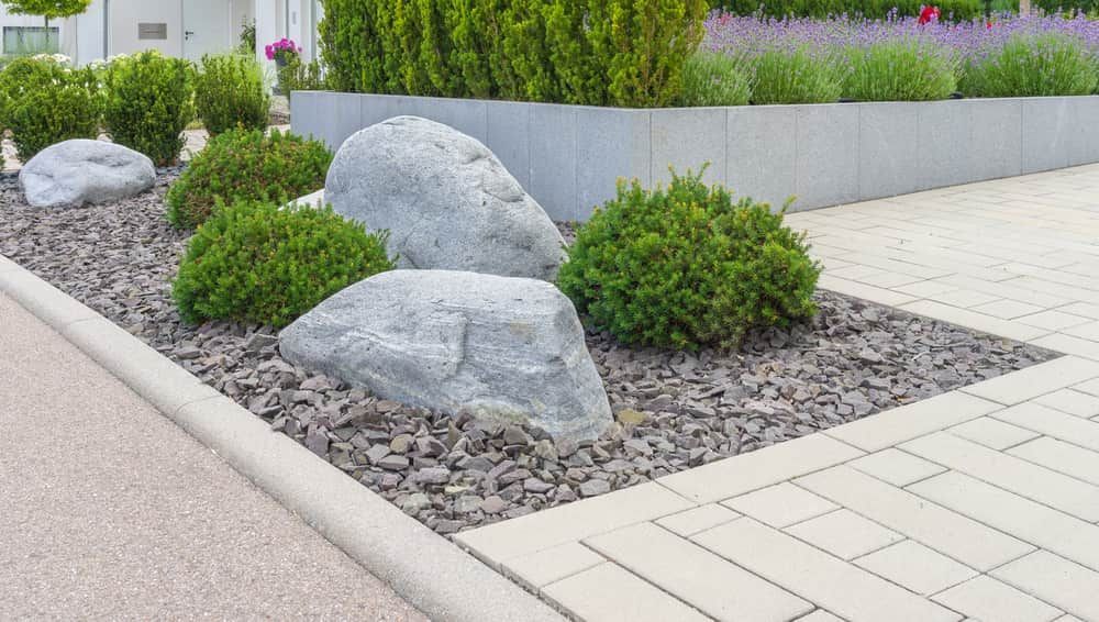 Modern Garden With Large Grey Boulders — Brett Continuous Concrete Kerbing & Edging In Lakewood, NSW