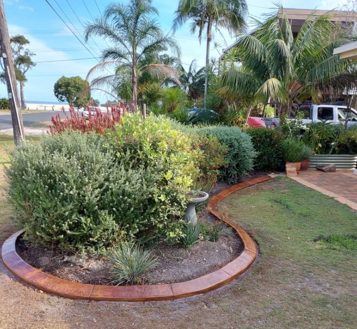 Lush Garden Bordered by a Curved Path — Brett Continuous Concrete Kerbing & Edging In Lakewood, NSW