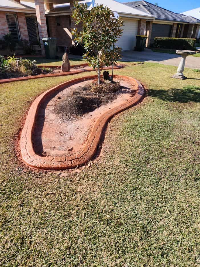 A Small Tree Planted With Red Brick Edging — Brett Continuous Concrete Kerbing & Edging In Laurieton, NSW