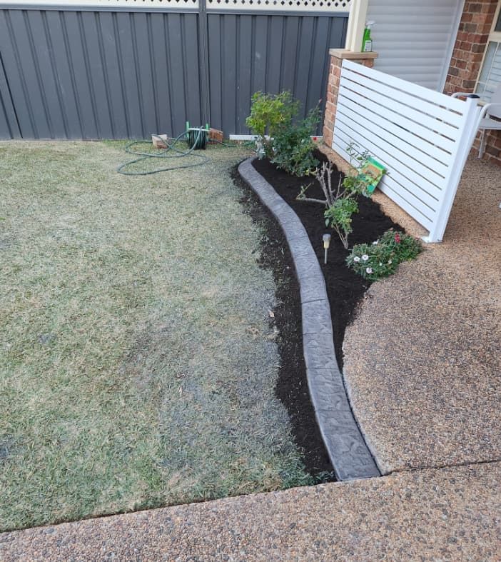 A Small Garden With Freshly Tilled Soil Borders — Brett Continuous Concrete Kerbing & Edging In Laurieton, NSW