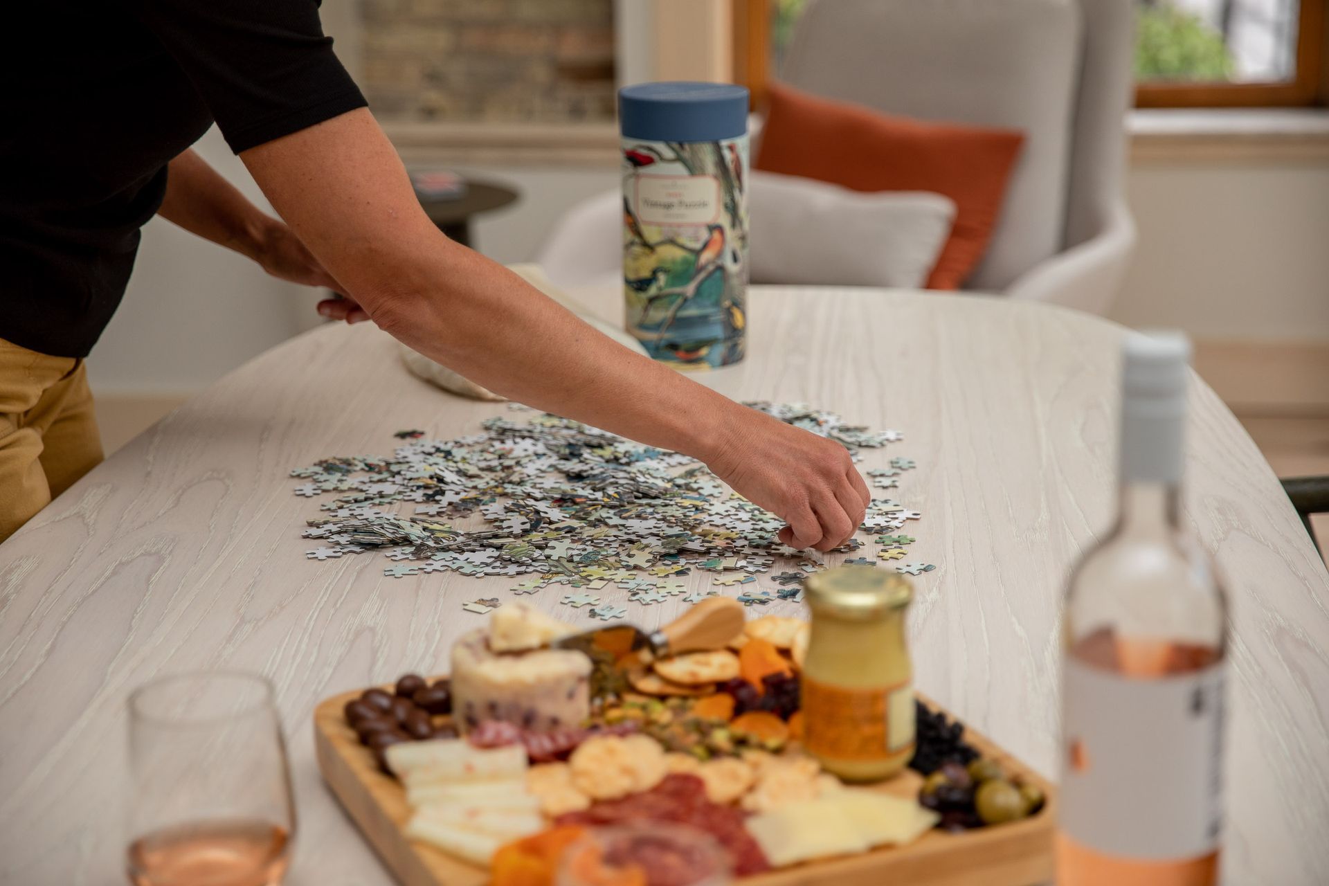 A person is putting a puzzle together on a table.