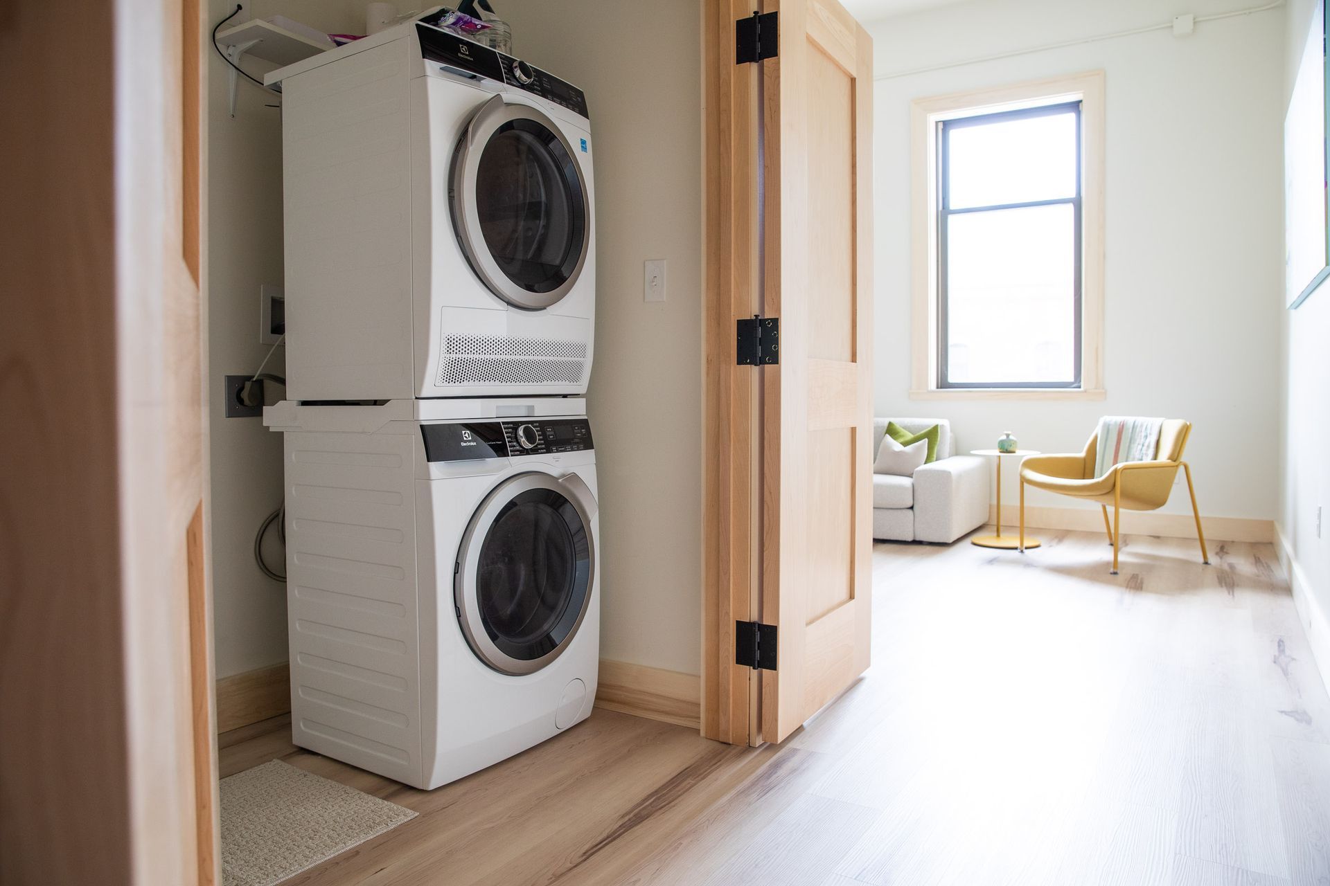 A washer and dryer are stacked on top of each other in a laundry room.